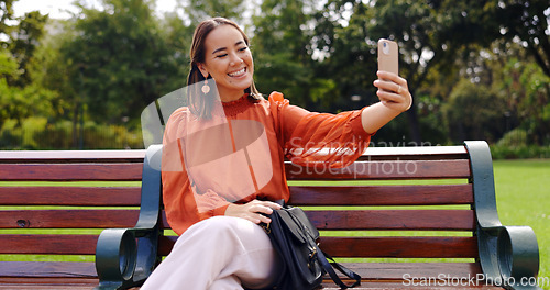 Image of Selfie, smile and Asian woman on bench at park taking pictures for social media. Summer, profile picture and person sitting outdoor taking photo for happy memory, tongue out or funny face alone.