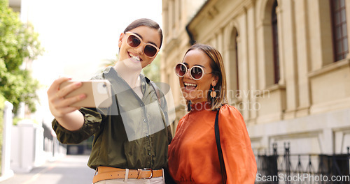 Image of Selfie, friends and business people in a city happy, smile and excited for travel, trip and photo. Smartphone, photography and women influencer pose for profile picture, web or blog update in London