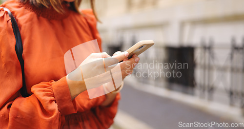 Image of Hands, typing and phone in city for social media, online browsing or web scrolling in urban street. Cellphone, woman and person text messaging, networking on app and internet search outdoor in town.