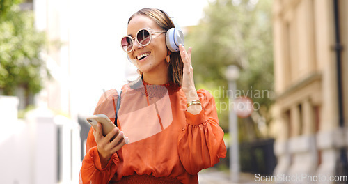 Image of Phone, music and woman dance in a city with headphones, happy and good mood outdoors. Radio, street and asian female dancing to podcast , excited and cheerful, free or positive in London