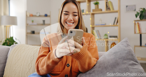 Image of Woman, phone and video call on home sofa with internet connection to wave hand for hello while talking. Asian female happy, relax and online for a conversation on social media or communication app