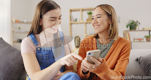 Image of Happy, friends and women on sofa, cellphone and online reading with social media, joyful and relax in living room. Females, girls and smartphone in lounge, search internet for videos or rest together
