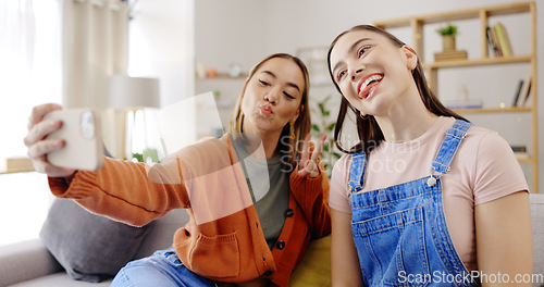 Image of Selfie, happy and women or friends on sofa for social media update, influencer post or digital memory with emoji face. Young, gen z people in profile picture or photography online and peace hand sign