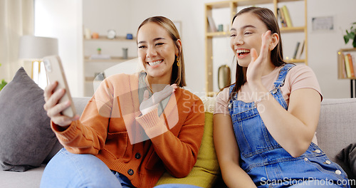 Image of Video call, phone and women or friends on sofa talking online, live streaming or social networking at home. Virtual communication, wave hello and young people on couch and mobile app conversation