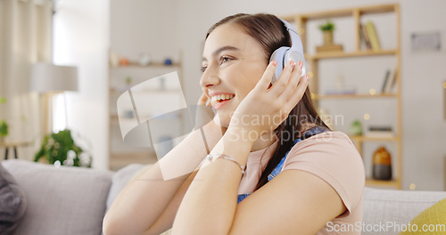 Image of Music, headphones and happy woman on couch streaming for mental health, relaxing and energy for home wellness. Young person in lounge or sofa listening to youth radio on audio technology and internet
