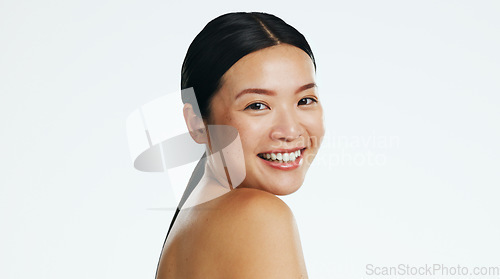 Image of Asian woman, skincare and face of beauty, smile and laser transformation on studio white background. Happy model, portrait and aesthetic wellness for salon cosmetics, healthy shine and dermatology