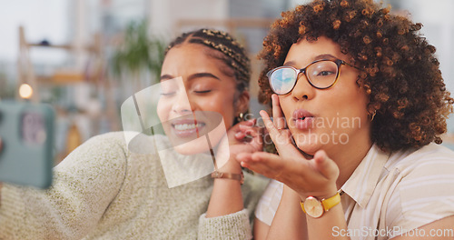 Image of Happy women smiling for photo, memory or facial expression for social media post. Woman, friends and smile for selfie, vlog or profile picture together blowing kiss by living room table at home.