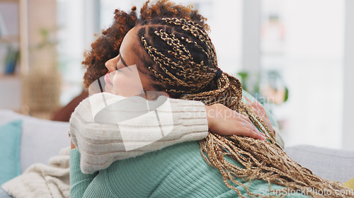 Image of Friends, women hug and talking on sofa, bonding in home living room and communication. Girls, friendship love and smile of happy females hugging, embrace or cuddle, chatting, speaking or discussion.