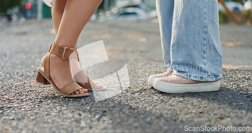 Image of Feet, closeup and women in a road, shy and flirting while on their first date in a city. Shoes, lgbtq and lesbian couple sharing cute, romance and gay relationship, bonding and standing in a street