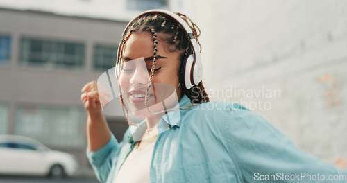 Image of Woman, dancing and listening to music in the city with headphones for audio streaming in the outdoors. Happy female dancer enjoying 5G connection with headset to listen for sound track in urban town