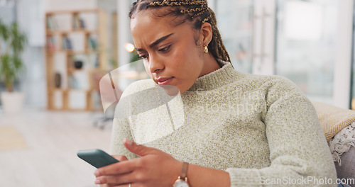 Image of Worried, woman on couch and smartphone with concerned expression, watching videos in living room. African American female, lady and cellphone with network signal, social media or connection for commu