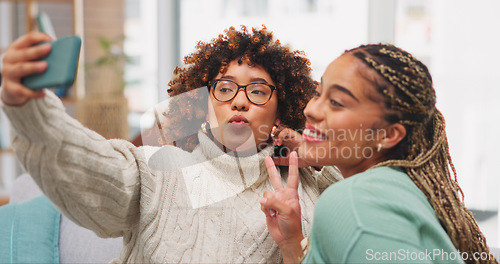 Image of Woman, friends and smile with peace sign for selfie, vlog or profile picture with facial expression on living room sofa at home. Happy women smiling for photo, memory or social media post on couch