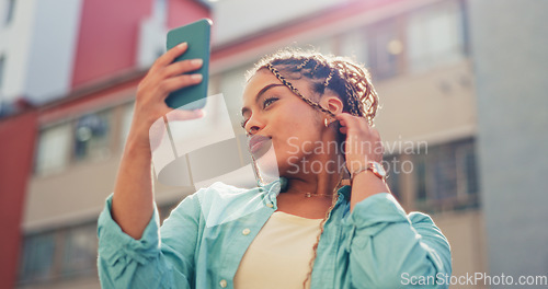 Image of Woman, travel and selfie in the city for vlog, profile picture or social media post in the outdoors. Happy female traveler smiling with facial expression for photo, memory or online vlogging in town