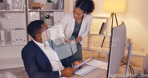 Image of Teamwork, documents and business people in office planning for project deadline, proposal or report at night on computer. Review, feedback and black woman talking to partner or manager for paperwork