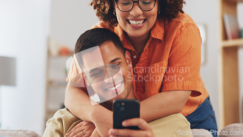 Image of Love, hug diversity, happy couple on sofa with phone, happiness and marriage in apartment. Smile, man and woman embrace on couch in living room, romance and quality time for bonding together in home.