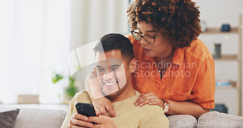 Image of Social media joke, phone and happy couple on sofa with smile, laugh and internet meme in apartment. Happiness, man and woman on couch in living room, laughing and checking funny post online together.