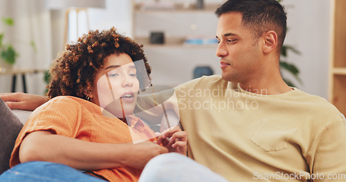 Image of Trust, empathy and a couple talking on a sofa in the living room of their home together for understanding or support. Communication, love or conversation with a man and woman bonding through sympathy