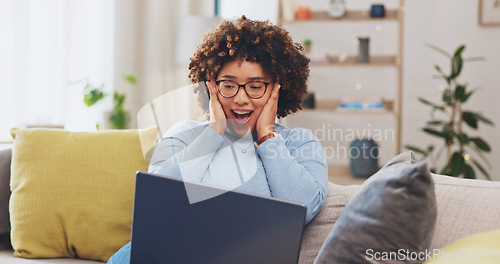 Image of Woman with laptop, fist pump and yes to win, person winning prize in competition or reward with success at home. Winner, email announcement with celebration, bonus and female cheers for achievement