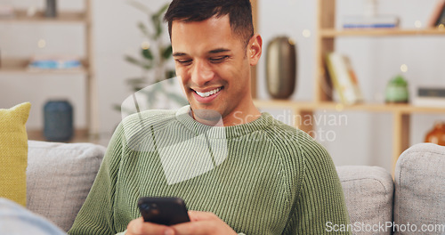 Image of Laughing, phone and relax with man on sofa for social media, internet and text message. Happy, smile and technology with male in living room at home for communication, connection and digital app