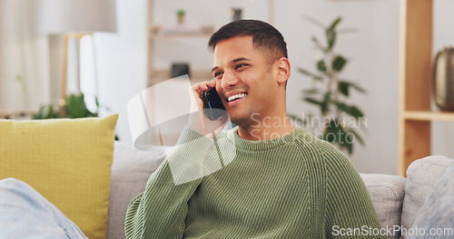 Image of Man, laughing and hello for talking with phone call in living room, communication or networking to chat on sofa. Happy male person, smartphone and smile for mobile conversation, contact or connection