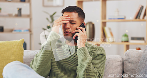 Image of Angry, man and phone call communication in home with anger problem, stress and conflict on sofa lounge. Frustrated male person, smartphone and talking for mobile conversation, argument and complaint