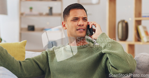 Image of Angry, frustrated and phone call of man in home with anger problem, stress and mad at hearing bad news. Confused, upset and unhappy male person talking on mobile conversation, argument and complaint