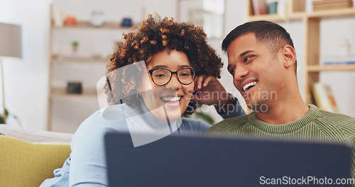 Image of Laptop, couple and happiness on sofa in home living room, relax and bonding together. Computer, talking and man and woman on couch online browsing, streaming movie and watching interracial video.