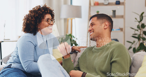 Image of Couple have conversation, communication and funny story in living room, spending quality time together on couch. Partner, love and respect, people talking and connection with laughter and happiness