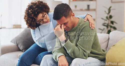 Image of Grief, loss with mental health and sad, stress and people in relationship in crisis. Couple, depression and woman comfort man with empathy, support and love while sitting in living room at home.