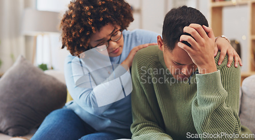 Image of Couple, depression and woman comfort man with empathy, support and love while sitting in living room at home. Grief, loss with mental health and sad, stress and people in relationship in crisis