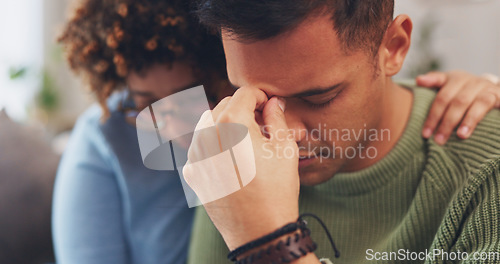 Image of Couple is sad, woman comforting man with empathy, support and love while sitting in living room at home. Grief, loss and mental health with depression, stress and people in relationship in crisis