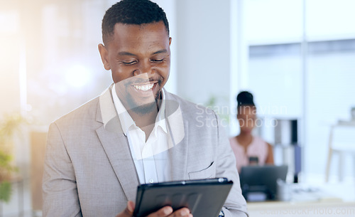 Image of Funny, tablet and businessman laughing at social media meme in the internet or online while working in an office. Joke, corporate and black man entrepreneur laugh at fake news on the web or website