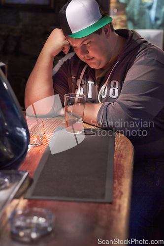 Image of Beer, pub alcohol and sad man depression over emotional crisis, worry or health risk at restaurant, diner or bar. Plus size, drink and drunk person depressed over fail, lonely or thinking of decision