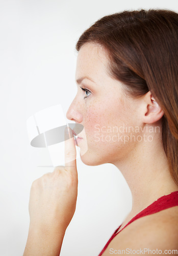 Image of Secret, hand and woman with finger on lips in studio for gossip, privacy or sign on white background. Whisper, profile and female person with silence, confidential or emoji with drama or announcement