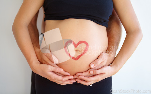 Image of Closeup, pregnant and woman with heart, stomach and bonding with nurture, health and wellness. Zoom, couple and hands with love symbol, support and belly with childcare, pregnancy and wellness