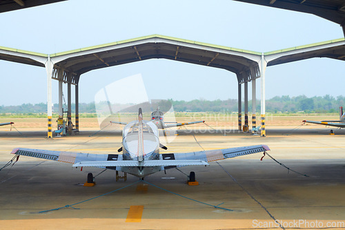 Image of Flight, military and hangar with plane at airport for rescue mission, transportation and emergency. Wings, airforce service and flying with fighter jet on runway for cargo, pilot and journey
