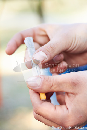 Image of Marijuana, rolling or hand with weed joint for a calm peace to relax or help reduce pain, stress or anxiety. Cannabis, smoking or closeup of person with a blunt for mental health benefits outdoors