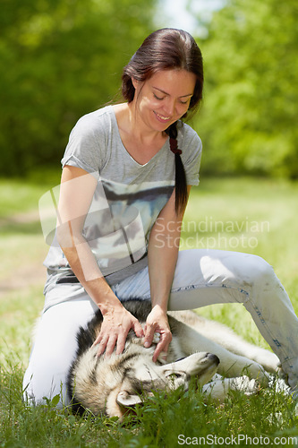 Image of Woman, husky and smile for playing in field, park or garden with love, bond and care in summer sunshine. Girl, pet dog and happy in nature, backyard or grass with embrace on adventure in countryside