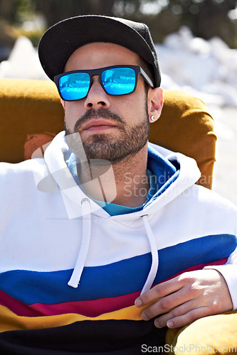 Image of Face, fashion and man with glasses in a city, chill and attitude, young and stylish on blurred background. Trendy, sunglasses and male person with confidence, casual and cool clothes while downtown