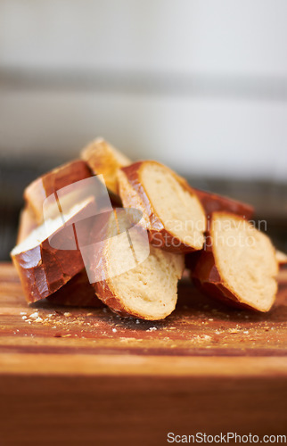 Image of Cooking, food and bakery with bread in kitchen for nutrition, health and diet. Breakfast, cafe and coffee shop with closeup of product on cutting board on table for wheat, grain and wellness