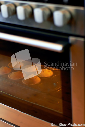 Image of Cupcake in oven, dessert and bakery confectionery closeup, production and food with sweet baked goods. Luxury snack, baking process with hospitality and catering industry, cake and kitchen appliance