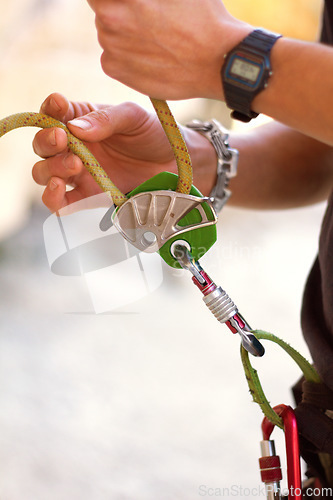 Image of Hand, closeup and rock climbing in safety harness for adventure, hiking or outdoor gear in summer. Hiker, rope knot or mountaineer in nature for exercise, training or fitness for freedom in sunshine