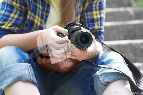 Image of Woman, photographer hands and camera for travel picture sitting on garden steps. Journey, photo and photography of a female person in a urban park traveling and outdoor on holiday with hobby