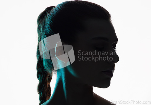 Image of Woman face, beauty and silhouette with shadow in studio for creativity, dark art deco and white background. Girl, model and neon profile for creative fantasy, dream aesthetic and mystery by backdrop