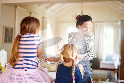 Image of Mom, playing or children baking in kitchen with messy kids siblings smiling with flour on dirty clothes at home. Smile, happy or parent cooking or teaching fun daughters to bake for child development