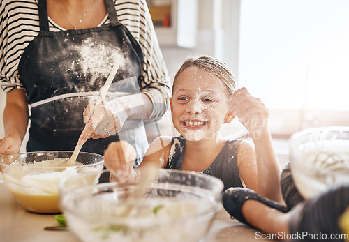 Image of Mom, playing or happy girl baking in kitchen as a happy family with a playful young kid with flour at home. Dirty, messy or mom helping, cooking or teaching fun daughter to bake for child development