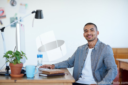 Image of Professional man, portrait and smile at creative startup, confidence with pride in agency workplace. Confidence, success and career mindset, male person at desk with ambition at advertising firm