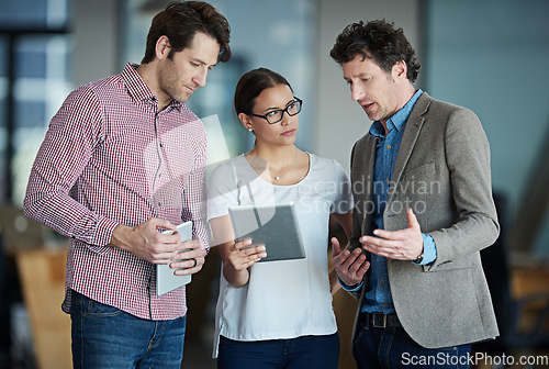 Image of Team discussion, tablet or business people with research in group meeting for talking together in office. Diversity, collaboration or employees speaking of technology or digital network in workplace