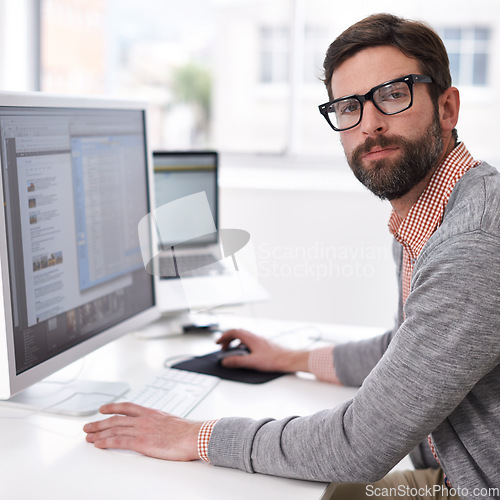 Image of Business man, serious portrait and computer coding of a IT professional at an office desk. Typing, cyber company and digital website design of an employee with pc technology at a startup workplace