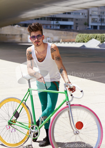 Image of Man, hipster fashion and portrait with bicycle outdoor in sunshine with unique personality, sunglasses and cool style. Young gen z guy, funky attitude and bike in summer, urban city and trendy person